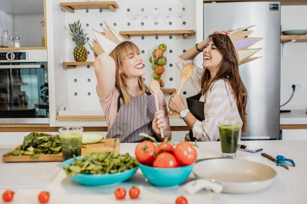 istock Two young female friends cooking in the kitchen 1294443776
