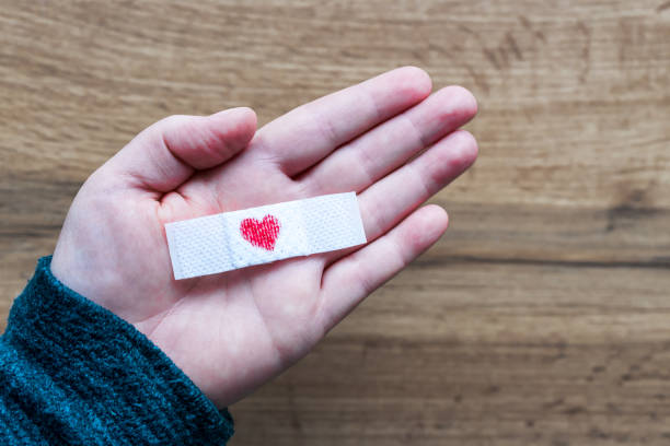 Band-aid with a heart on a hand