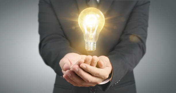istock Hand of holding illuminated light bulb, innovation inspiration concept 1294445548