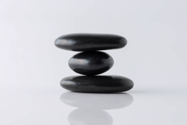 istock stacked black stones on white background 1294446606