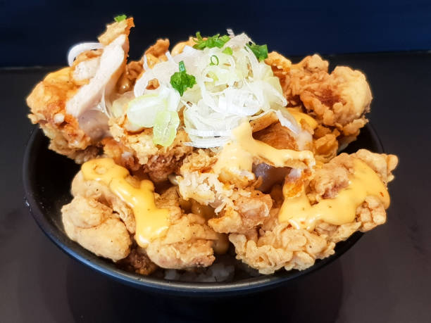 istock Fried chicken with mayonnaise sauce and rice on dish background 1294448312