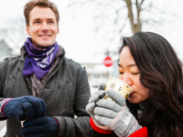 Mixed race couple drinking coffee outdoors