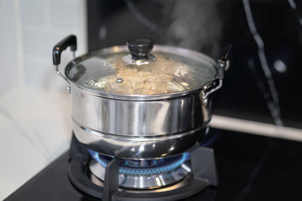 Christmas ham boiling on a gas stove in a large pot