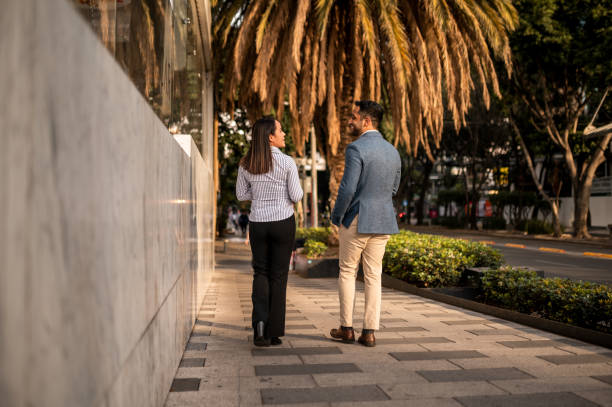 Two business persons walking down the street