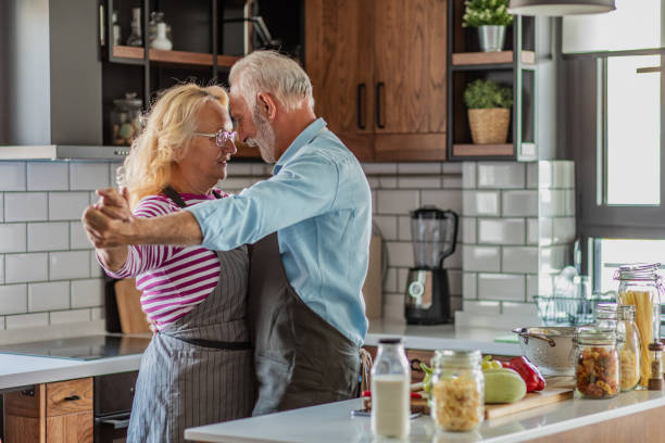 istock Senior couple dancing in the kitchen and having fun 1294455166