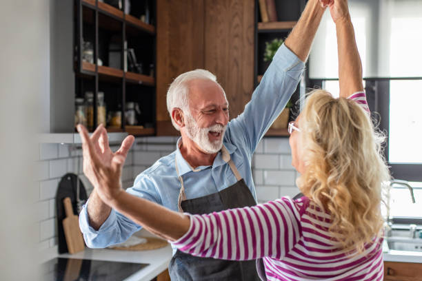 istock Senior couple dancing in the kitchen and having fun 1294455632