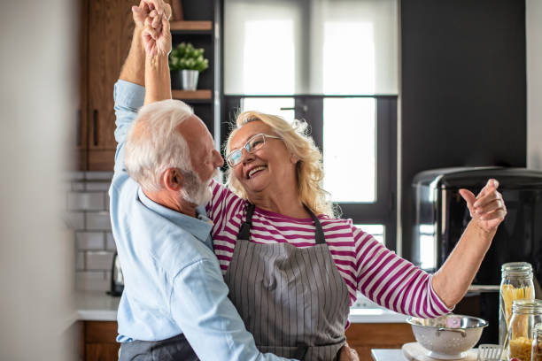 istock Senior couple dancing in the kitchen and having fun 1294455638