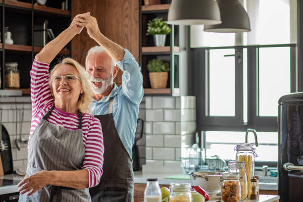 istock Senior couple dancing in the kitchen and having fun 1294456667