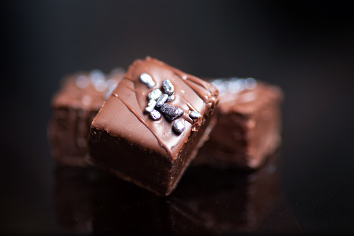 Homemade chocolate Praline candy desserts on a dark table closeup