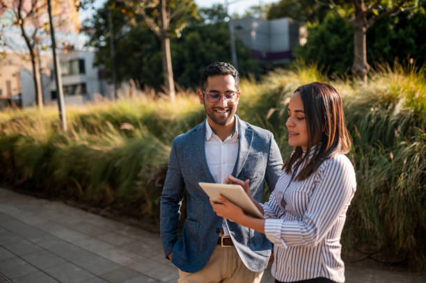 istock Young woman typing on the tablet and man is looking 1294457569