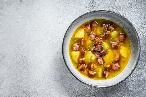 German Split pea soup with smoked sausages. White background. Top view. Copy space.