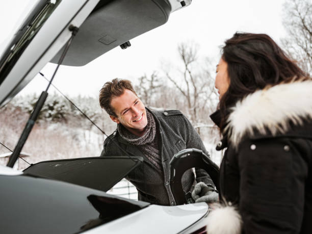 istock Mixed race couple unloading car in winter 1294460448