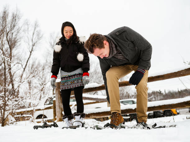 istock Mixed race couple snowshoeing in winter 1294460481