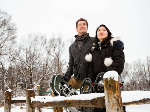 istock Mixed race couple snowshoeing in winter 1294460503