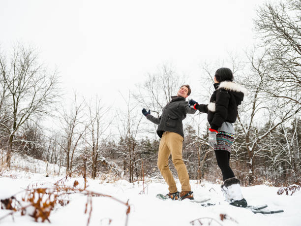 istock Mixed race couple snowshoeing in winter 1294461142