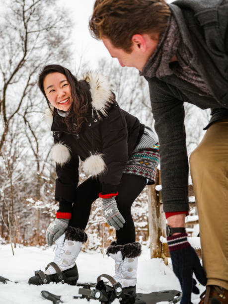 istock Mixed race couple snowshoeing in winter 1294461229