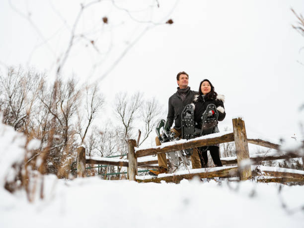 istock Mixed race couple snowshoeing in winter 1294461237