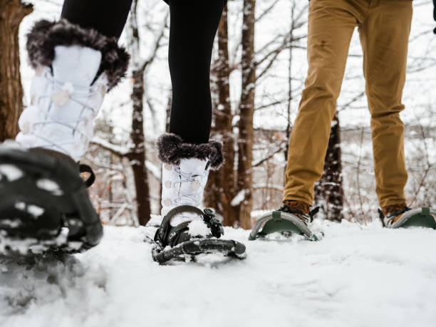 istock Mixed race couple snowshoeing in winter 1294461240