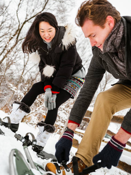 istock Mixed race couple snowshoeing in winter 1294461291