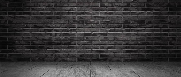 istock Empty room with black brick wall and concrete floor. Basement, garage in dark light. Brick wall in the interior. 3d image. 1294462840