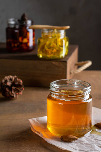 istock Three jars of honey on a wooden table 1294465197