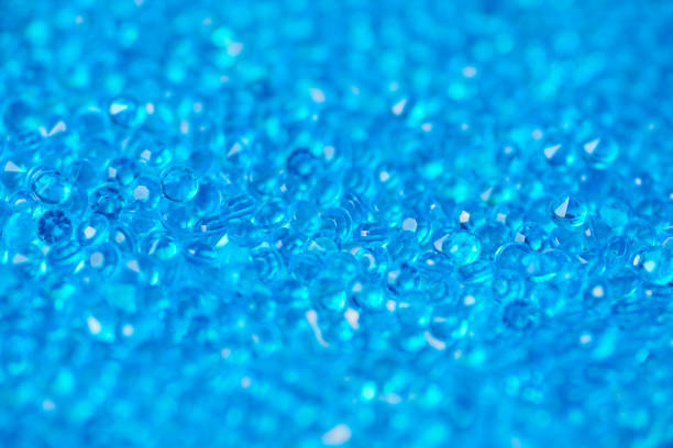 Aquamarine blue crystal mineral stone. Processed decorative diamond for inlaid jewelry. Stack of little gem crystals background.