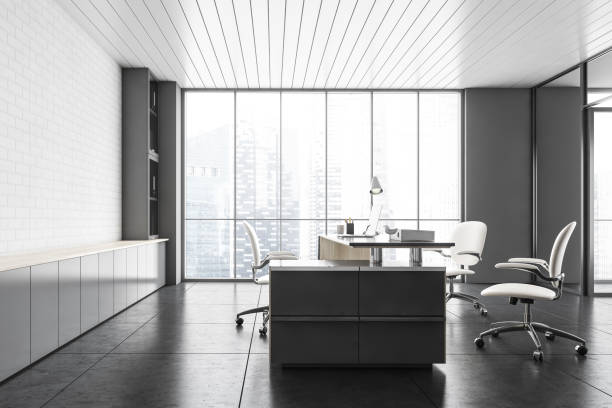 istock White office lobby room with laptop, chairs and table, brick wall and large window 1294466228