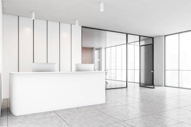 istock White office reception with laptops and glass conference room side view 1294466838