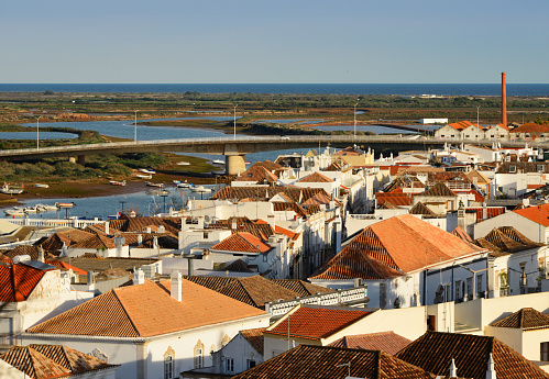 Tavira, Algarve / Faro district, Portugal: view over Tavira and the Gilão river estuary from the castle hill - saltpans and the Atlantic Ocean in the background.