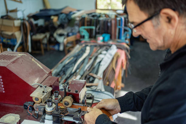 istock Man working at a craft production of leather goods 1294468928