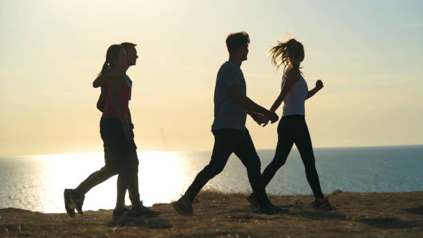 istock The four young people walking on the seascape background 1294468983