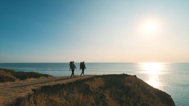 istock The two people hiking on the seascape background 1294468985