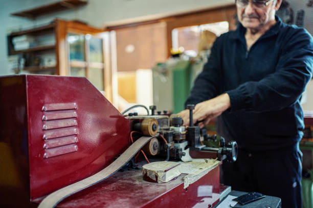 istock Man working at a craft production of leather goods 1294468987