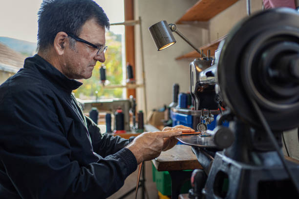 istock Man working at a craft production of leather goods 1294468997