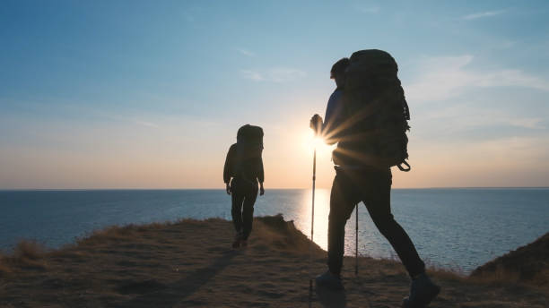 istock The two people hiking on the seascape background 1294469015