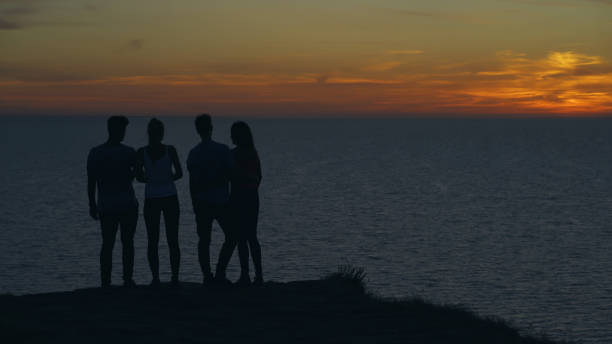 istock The four young people standing on the seascape background 1294469035