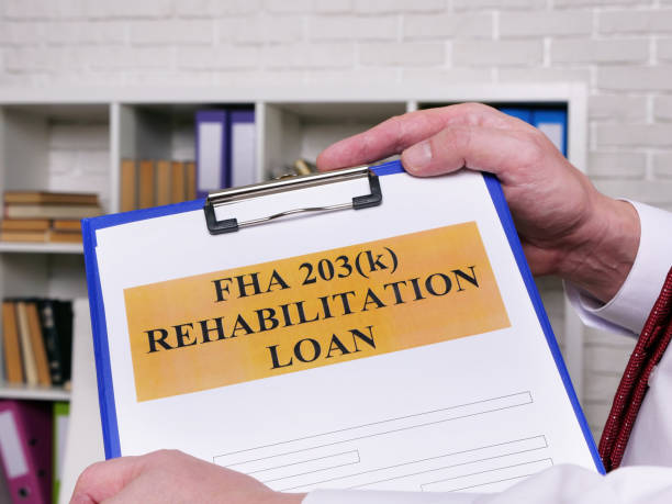 istock FHA 203k rehabilitation loan application form for signing. 1294470020