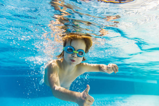 istock Close-up boy with thumbs up underwater 1294470511