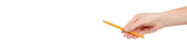 istock Hand with yellow writing pen isolated on white background. 1294471521