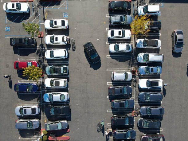 Aerial top view of parking lot with with varieties of colored vehicles Aerial top view of parking lot with many cars from above, city transportation and urban concept parking stock pictures, royalty-free photos & images