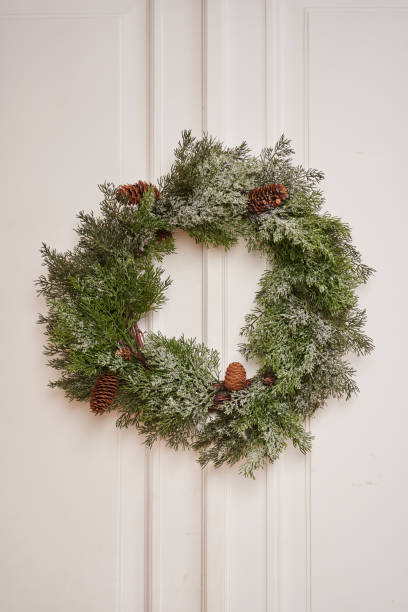 istock spruce wreath with cones on a white background 1294474860