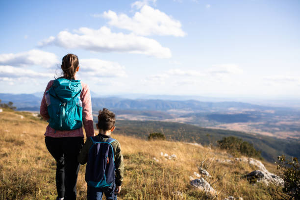 istock Mother and son holding hands while hiking 1294479491