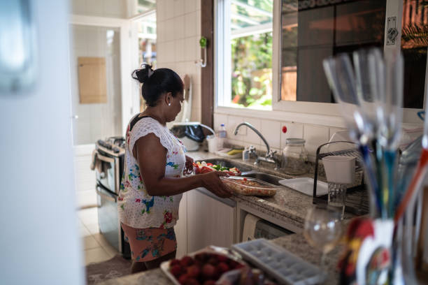 istock Mature woman making salad at home 1294480578