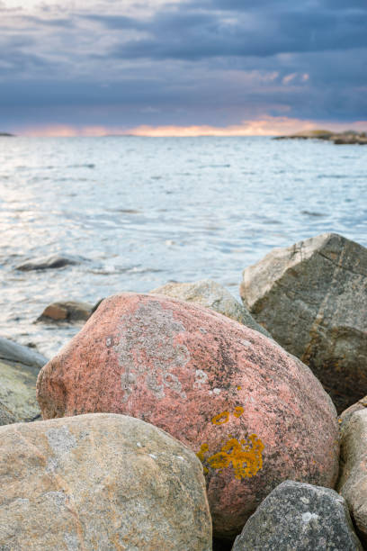 istock Old round boulders at the waterfront 1294481797