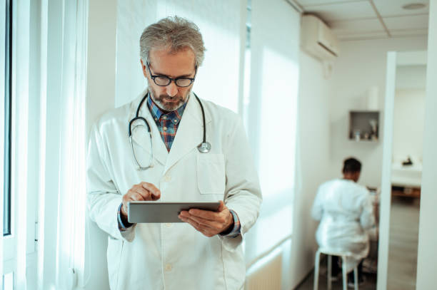 istock Doctor with his tablet at office 1294482987
