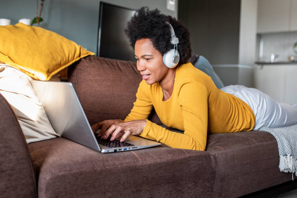 istock Woman relaxing at home and using laptop 1294483315