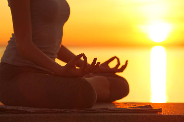 istock Woman silhouette doing yoga exercise at sunset 1294484096