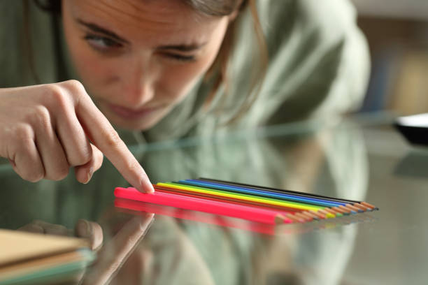 mujer obsesiva compulsiva alineando lápices en una mesa - obsesivo fotografías e imágenes de stock