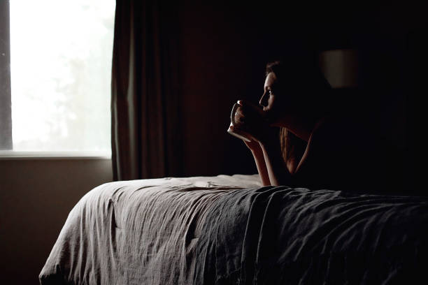 istock A woman drinking coffee on a bed 1294484979