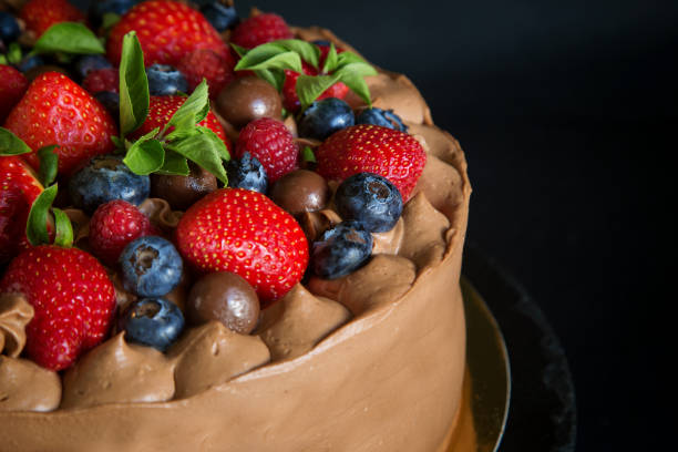 istock chocolate cake decorated with strawberries, raspberries and blueberries, top view 1294485204